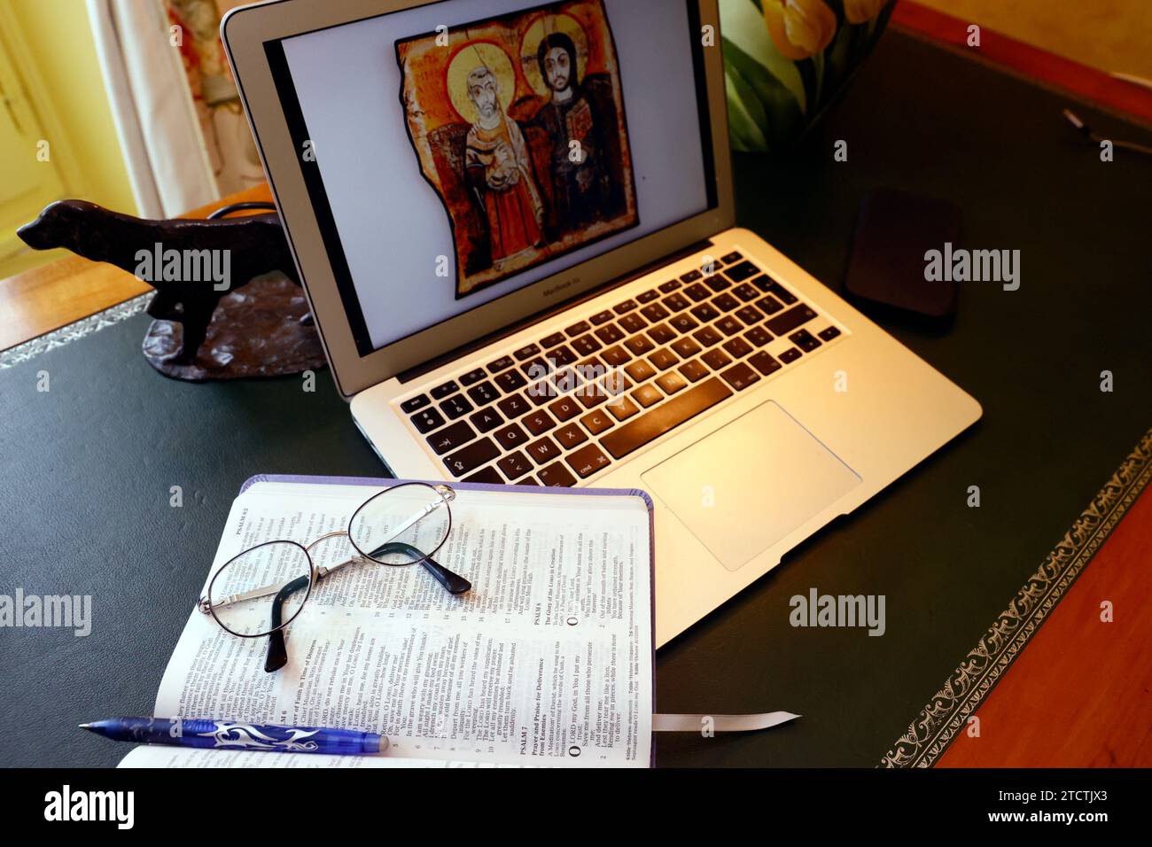 Bible study. Laptop and open bible with glasses. Stock Photo