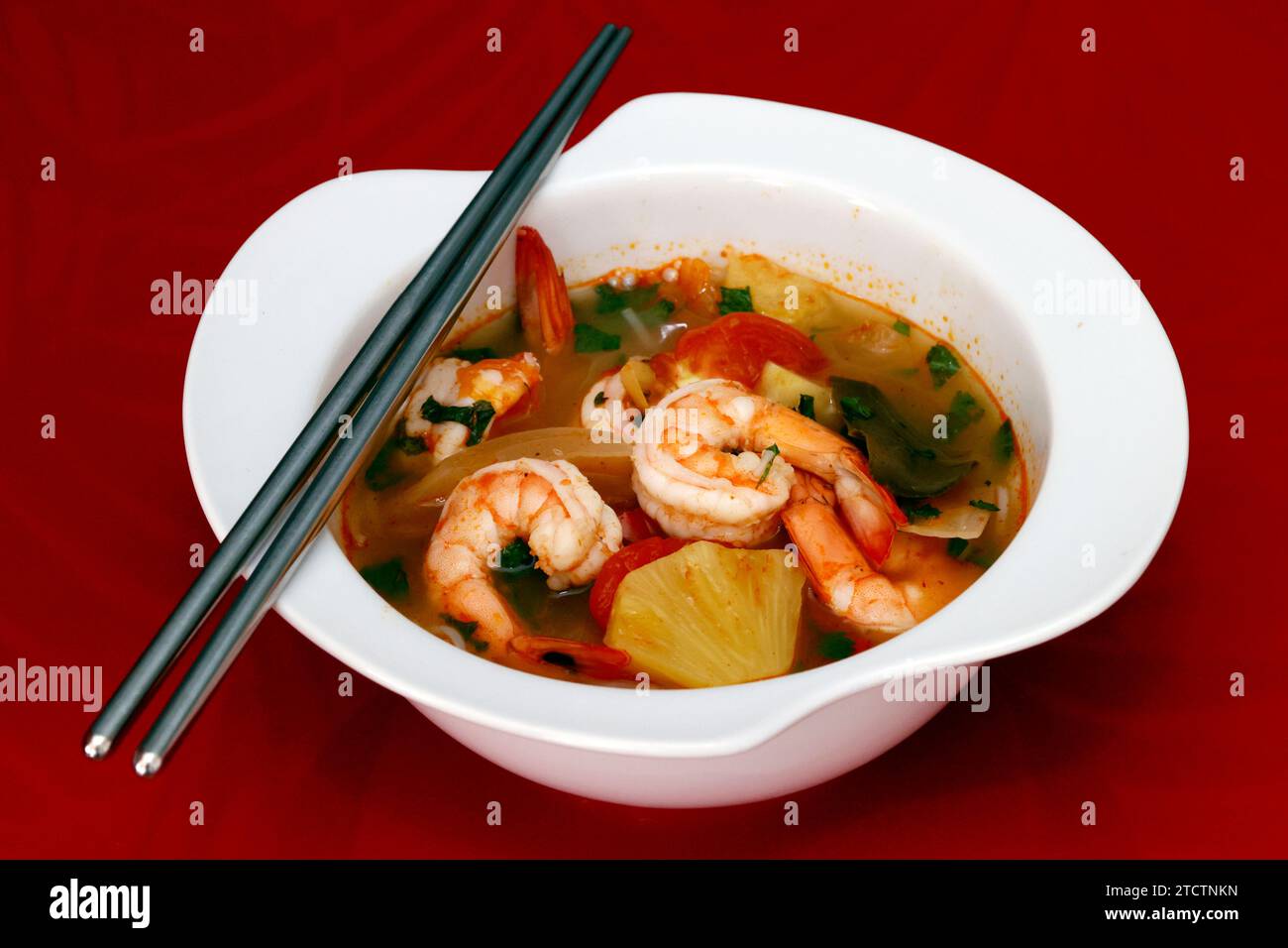 Bowl of spicy Thai Tom Yum Soup with prawns. Stock Photo