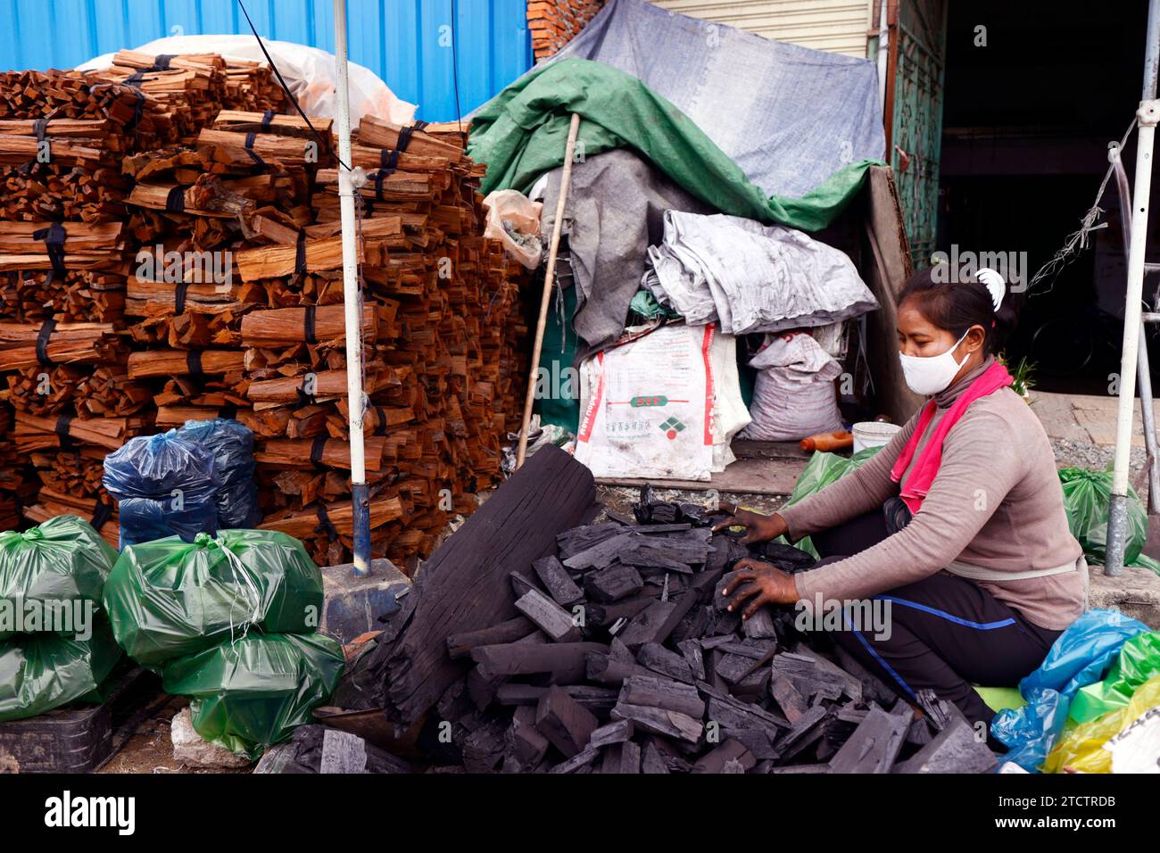 Woman making wooden charcoal. Hard work. Stock Photo