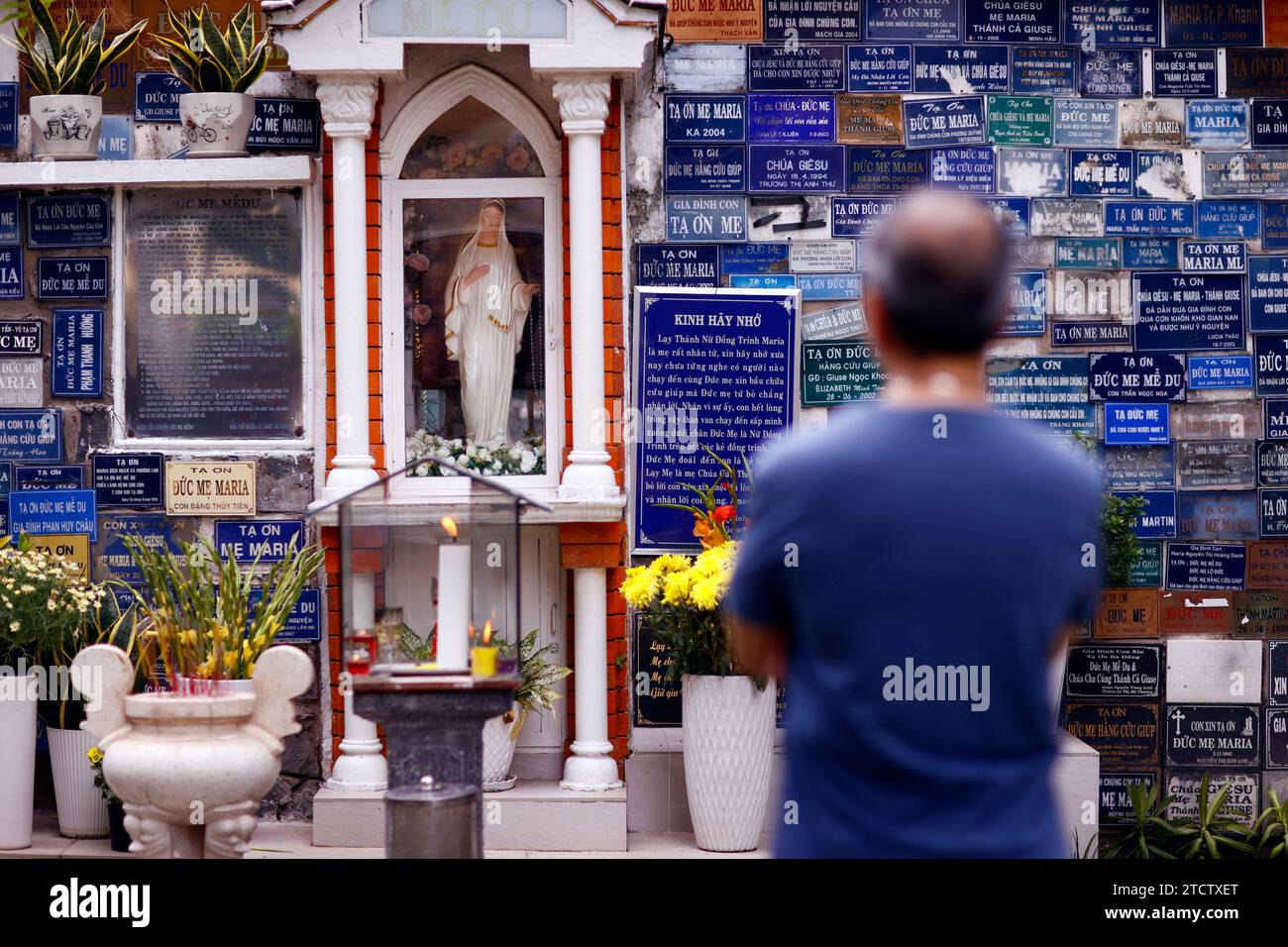 Huyen Si Church. Man praying the Virgin Mary.   Ho Chi Minh city. Vietnam. Stock Photo