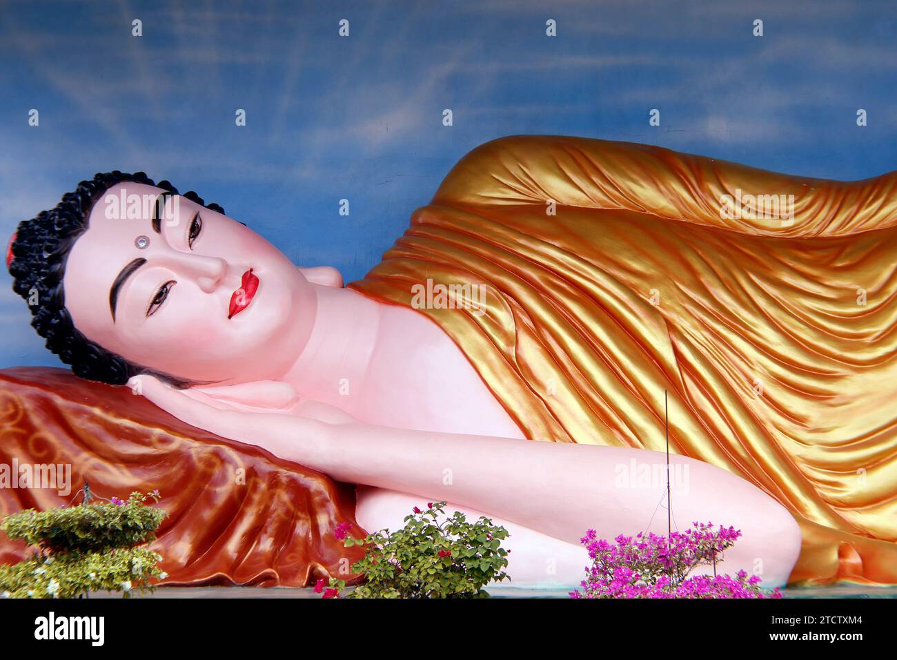 Phuoc Hue buddhist pagoda. Giant gold reclining sleeping Buddha statue. Vietnam. Stock Photo