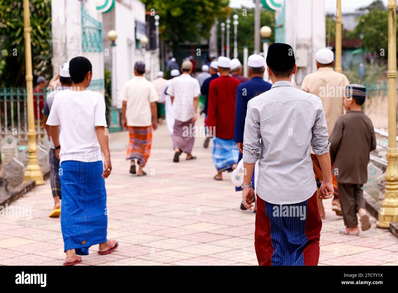 Cham community. Men coming out from the  mosque. Backview.  Vietnam. Stock Photo
