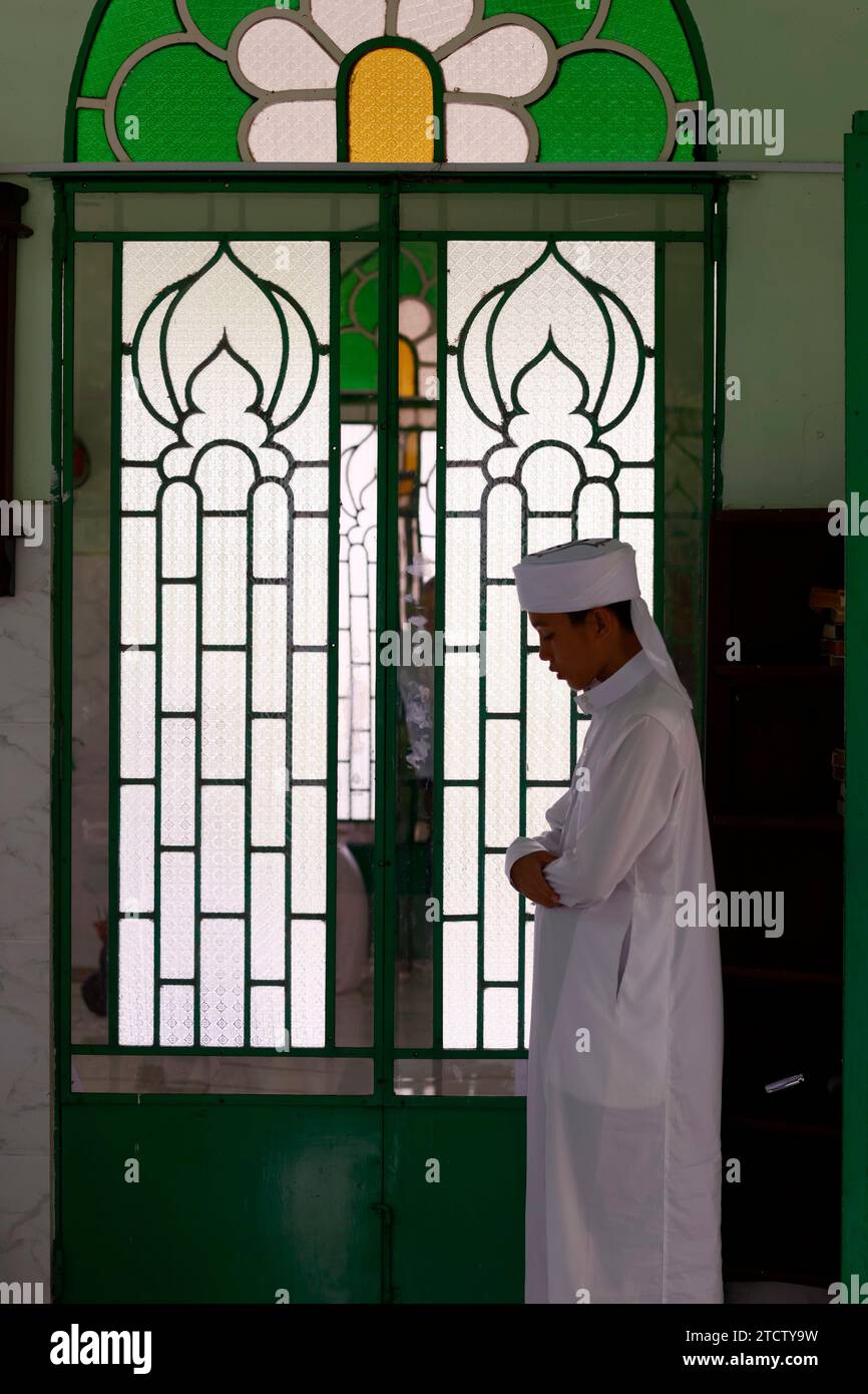 Jamiul Azhar mosque.  The friday prayer (salat). Muslim man praying in mosque. Vietnam. Stock Photo