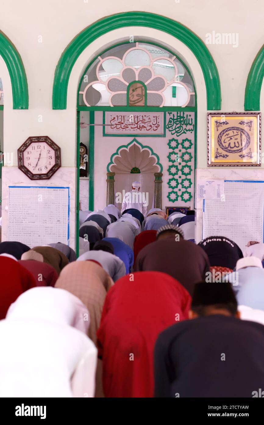 Jamiul Azhar mosque.  The friday prayer (salat). Muslim men praying in mosque. Vietnam. Stock Photo