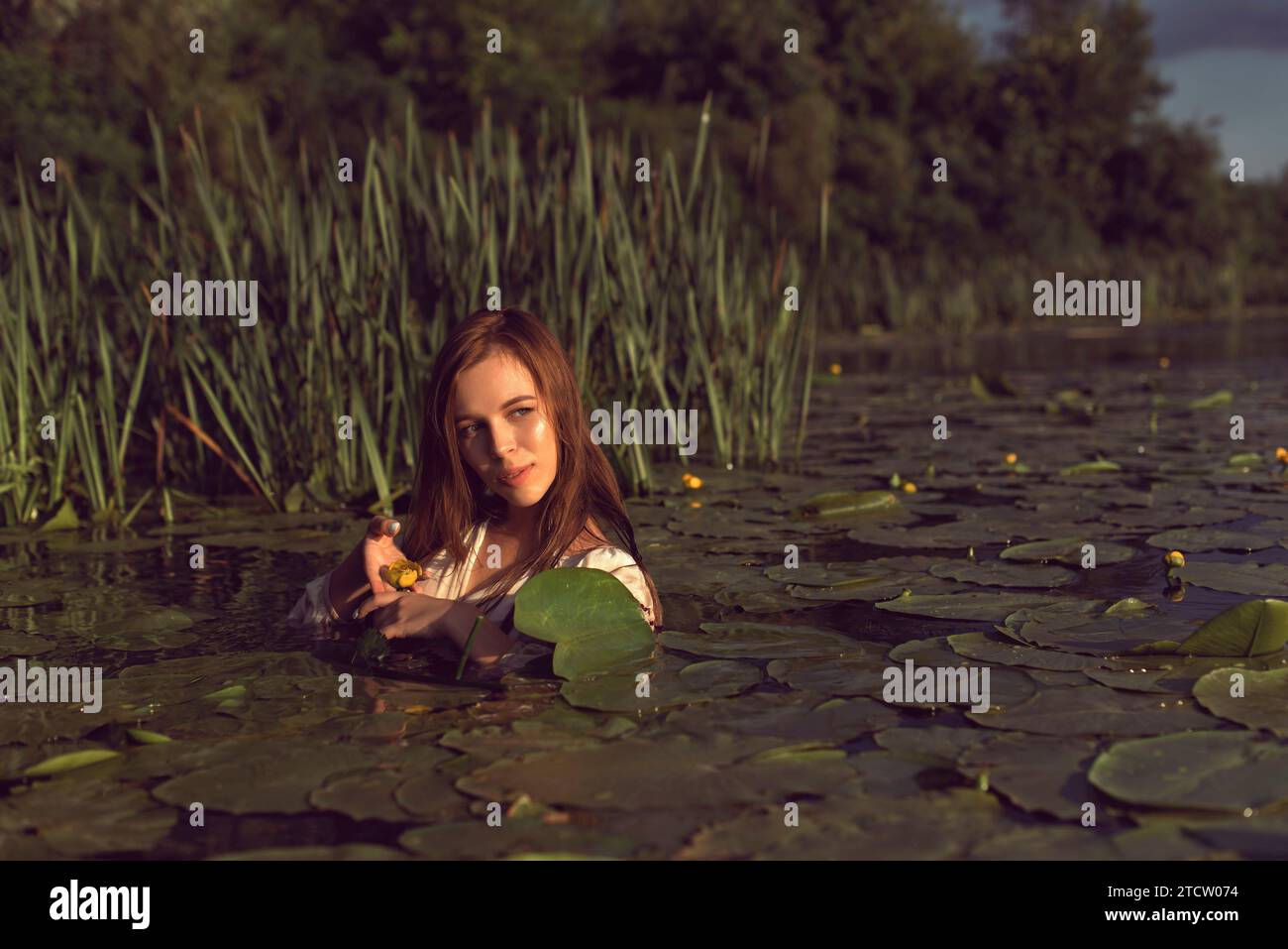 Girl in an embroidered dress on the lake Stock Photo - Alamy