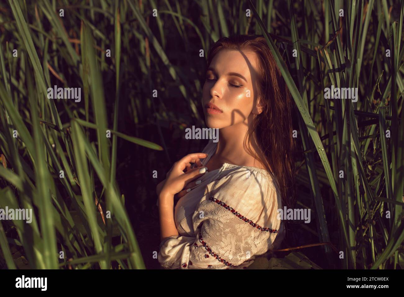 Girl in an embroidered dress on the lake Stock Photo - Alamy