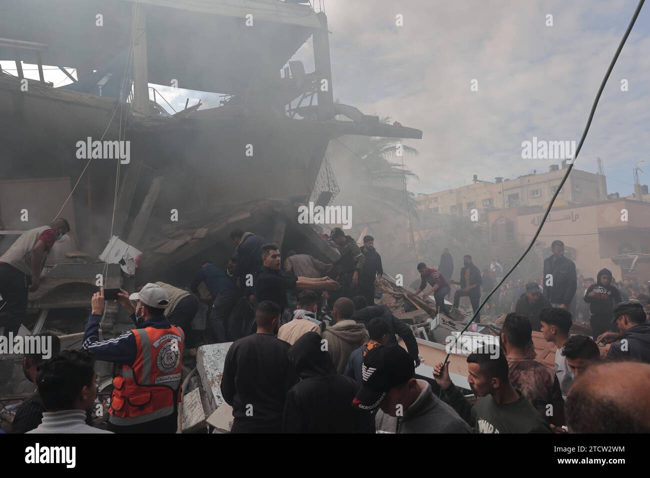 Rescuers and civilians look for survivors amid the rubble of destroyed ...