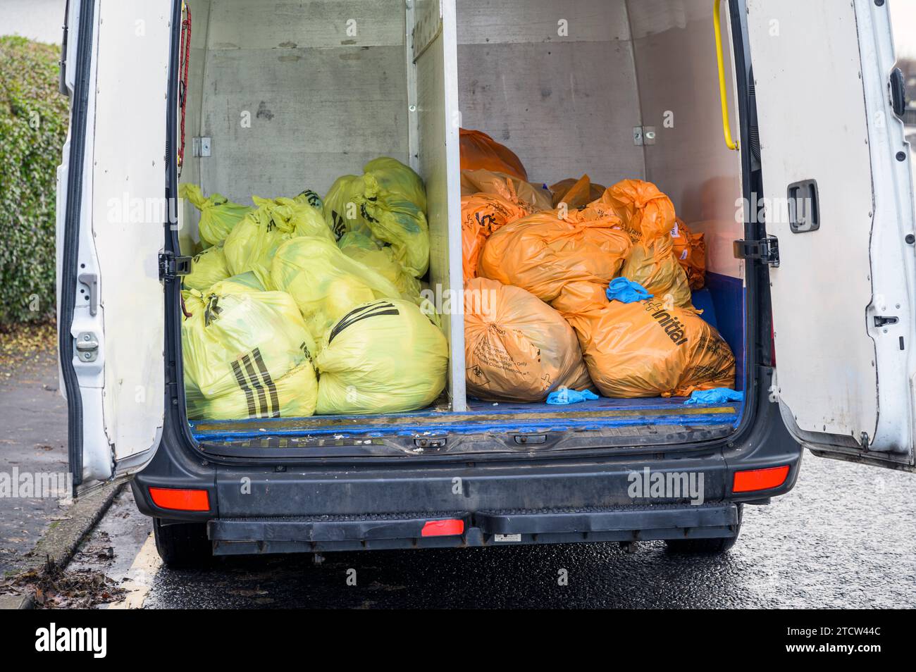 Initial Waste Management collected and separated into orange and yellow bags inside a van, Glasgow, Scotland, UK, Europe Stock Photo