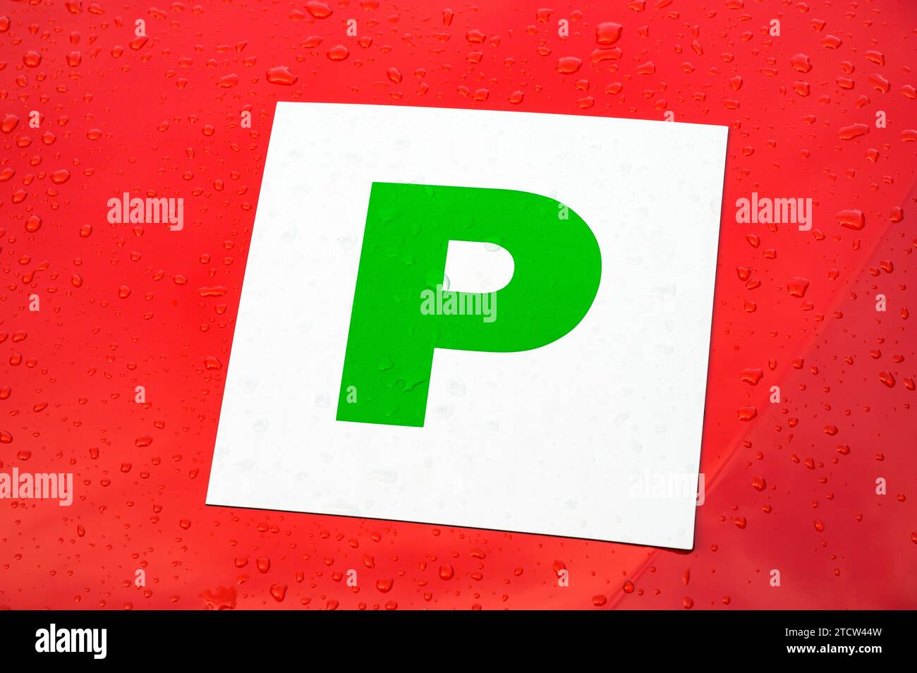 Green probationary P plate on a red car Stock Photo