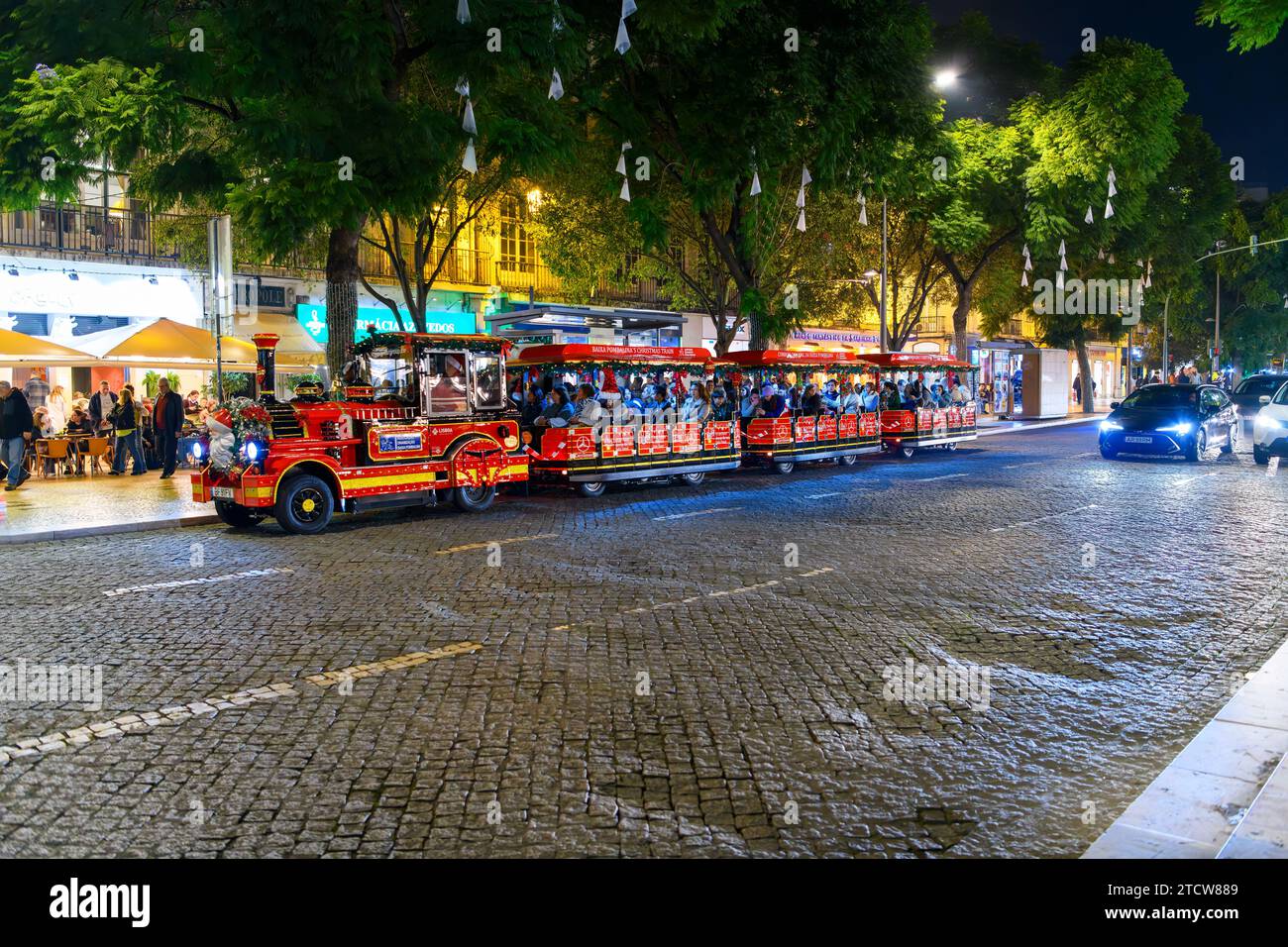 A crowded Christmas Train at the Rossio Square Christmas Market, Mercado de Natal, in the historic center of Lisbon, Portugal. Stock Photo
