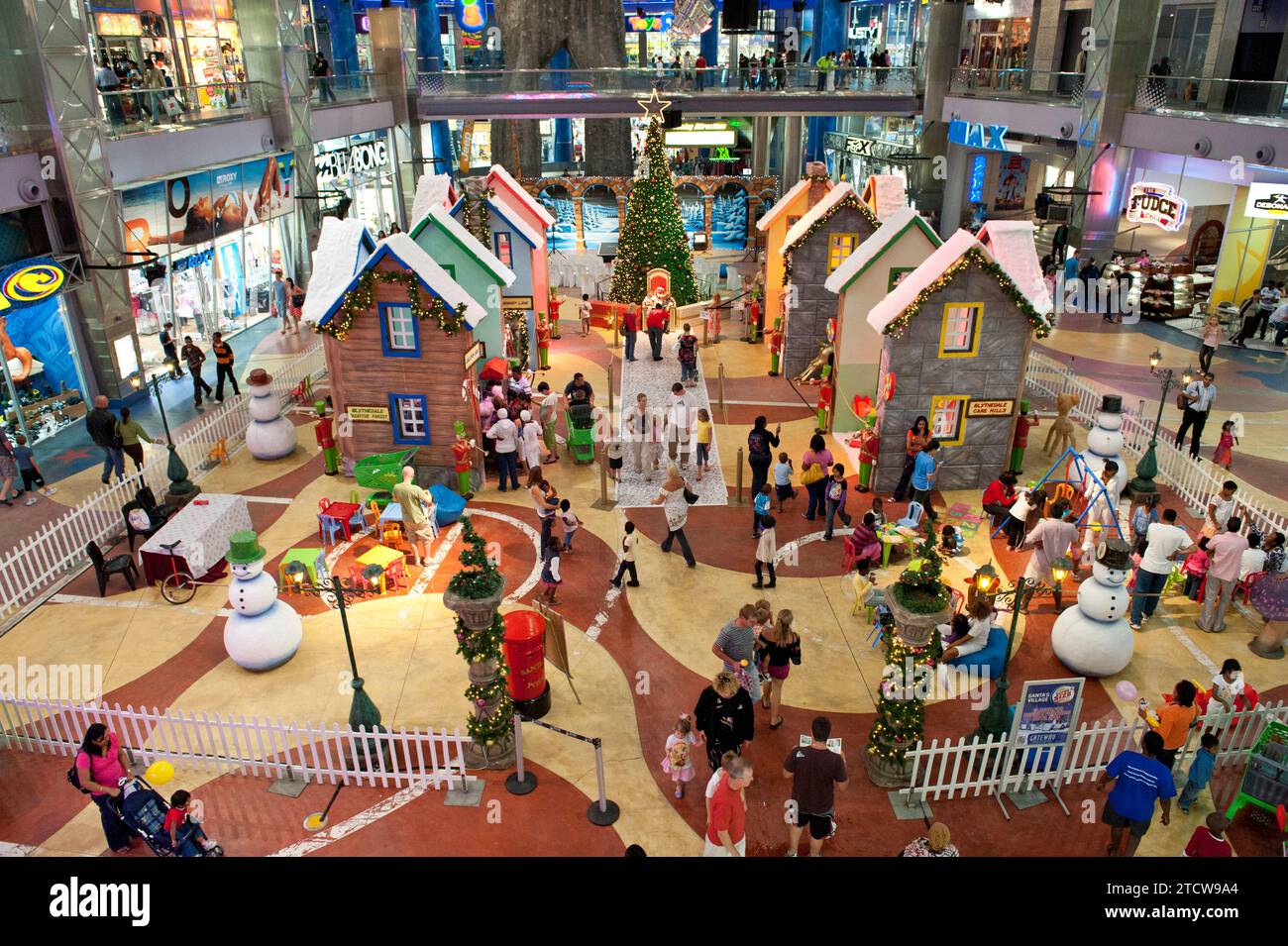 A Christmas village for children at the Gateway Theatre of Shopping in Umhlanga. Every year as part of the festive season Gateway constructs a special area that families and kids can come to enjoy Father Christmas or Santa Claus. Gateway Theatre of Shopping or Gateway is one of the largest shopping centre in Africa and the largest in the southern hemisphere. It is located on Umhlanga Ridge in Umhlanga, north of Durban, KwaZulu-Natal, South Africa. Gateway is particularly busy over the festive season when thousands of shoppers visit the centre to do their shopping.   Construction commenced on 3 Stock Photo