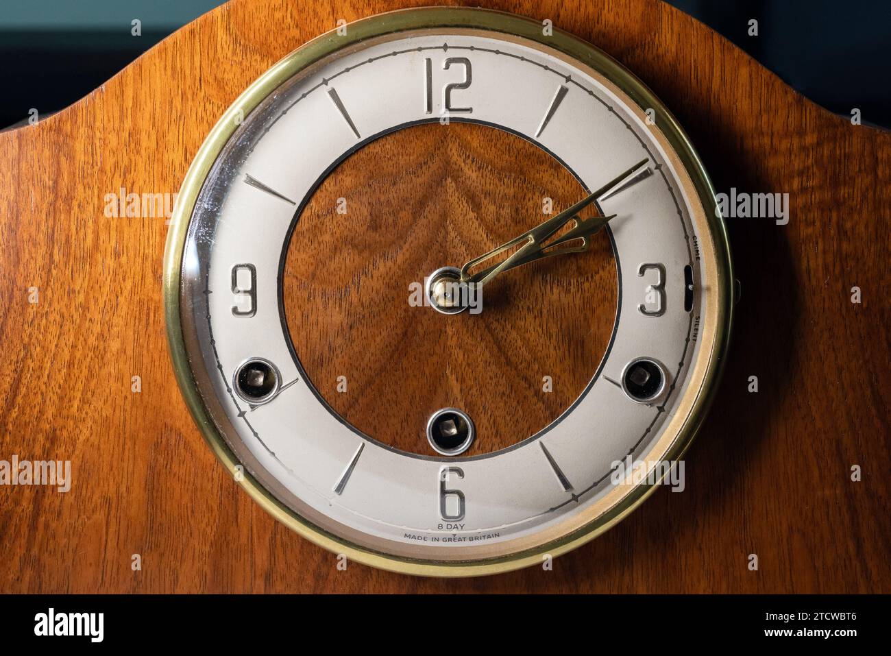 Vintage chiming mantel clock, close up photo, front view. White clock