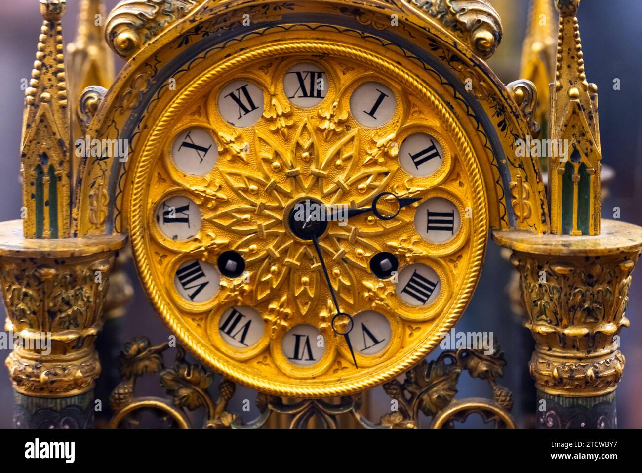 Vintage chiming grandfather clock dial with golden decoration in Gothic