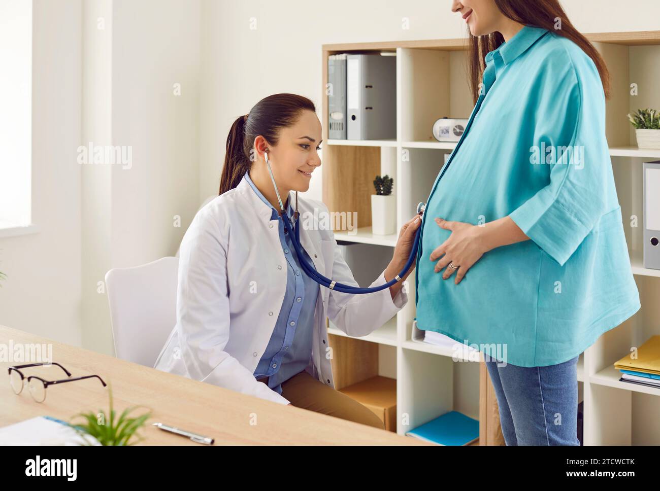 Doctor stethoscope pregnant woman belly hi-res stock photography