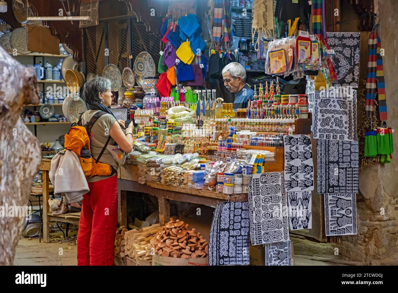 Western tourist buying souvenirs in gift shop in Souk el Henna in the old medina of the city Fes / Fez, Fez-Meknes, Morocco Stock Photo