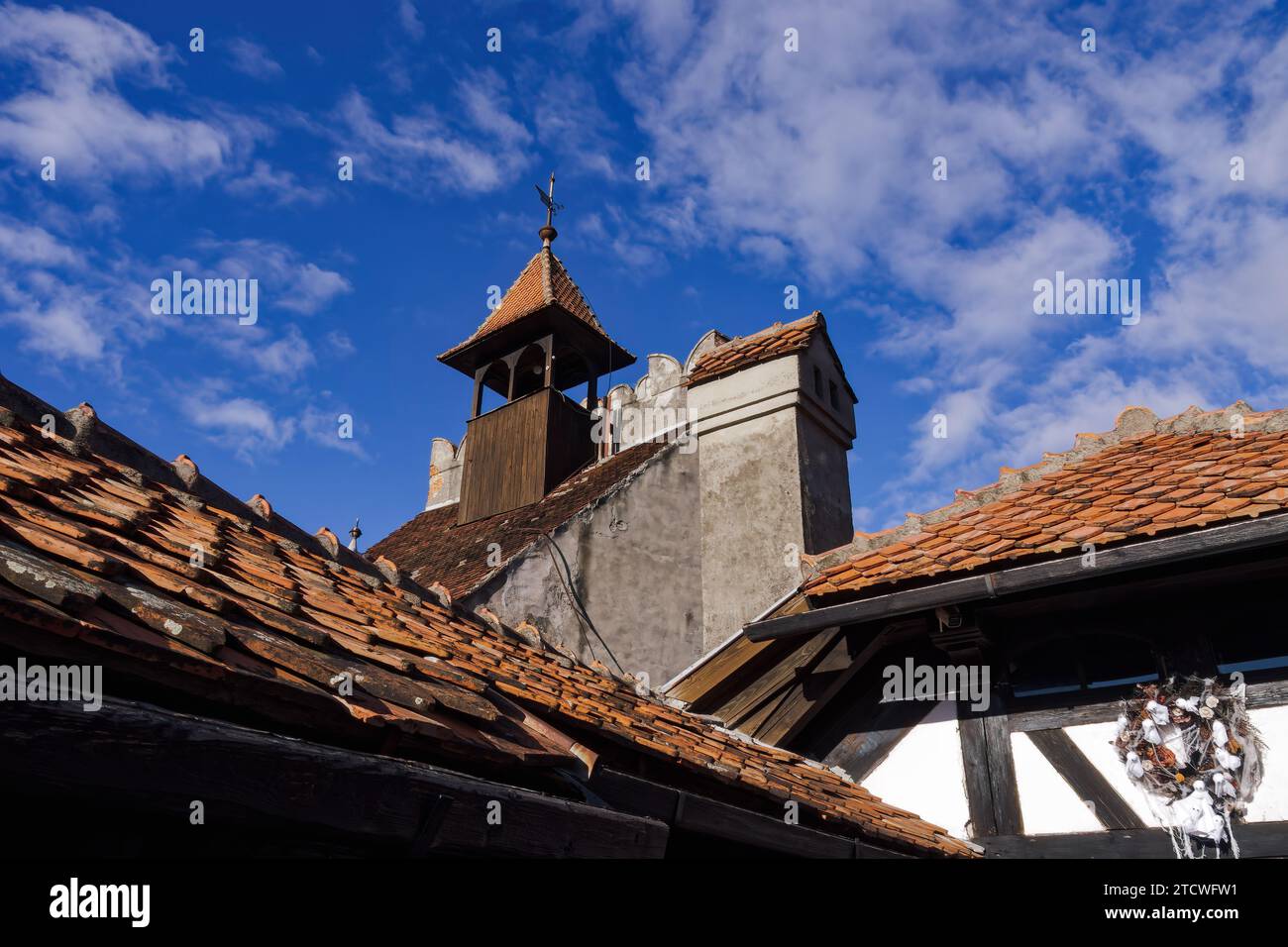 Bran Dracula Castle red tiled rooftop against blue sky in Romania ...