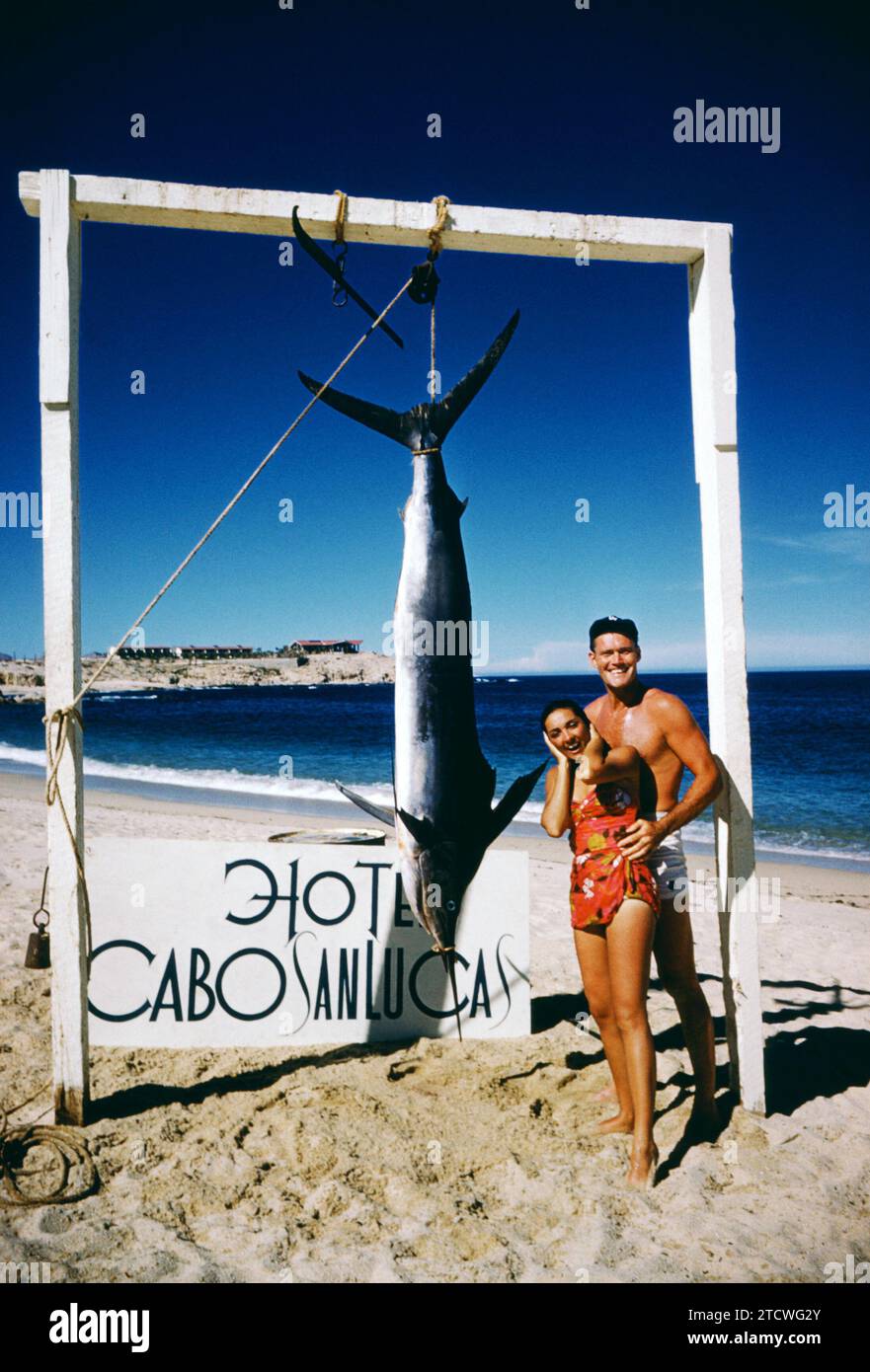 BAJA CALIFORNIA, MEXICO - JUNE, 1962:  Actor and former baseball player Chuck Connors (1921-1992) and actress fiance Kamala Devi (1934-2010) pose for a portrait in front of a Marlin that Connors caught while on a fishing trip circa June, 1962 in Baja California, Mexico.  (Photo by Hy Peskin) *** Local Caption *** Chuck Connors;Kamala Devi Stock Photo