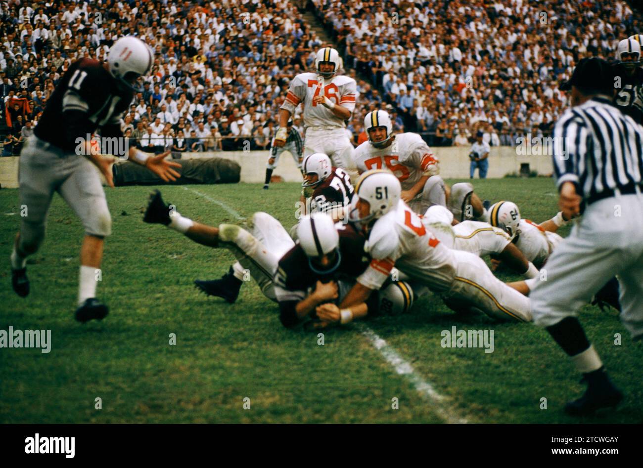 DALLAS, TX - SEPTEMBER 21:  An unidentified player of the #2 ranked Texas A&M Aggies is tackled by a group of players from the Maryland Terrapins during the game on September 21, 1957 at the Cotton Bowl in Dallas, Texas.  The Aggies defetead the Terrapins 21-13.  (Photo by Hy Peskin) Stock Photo