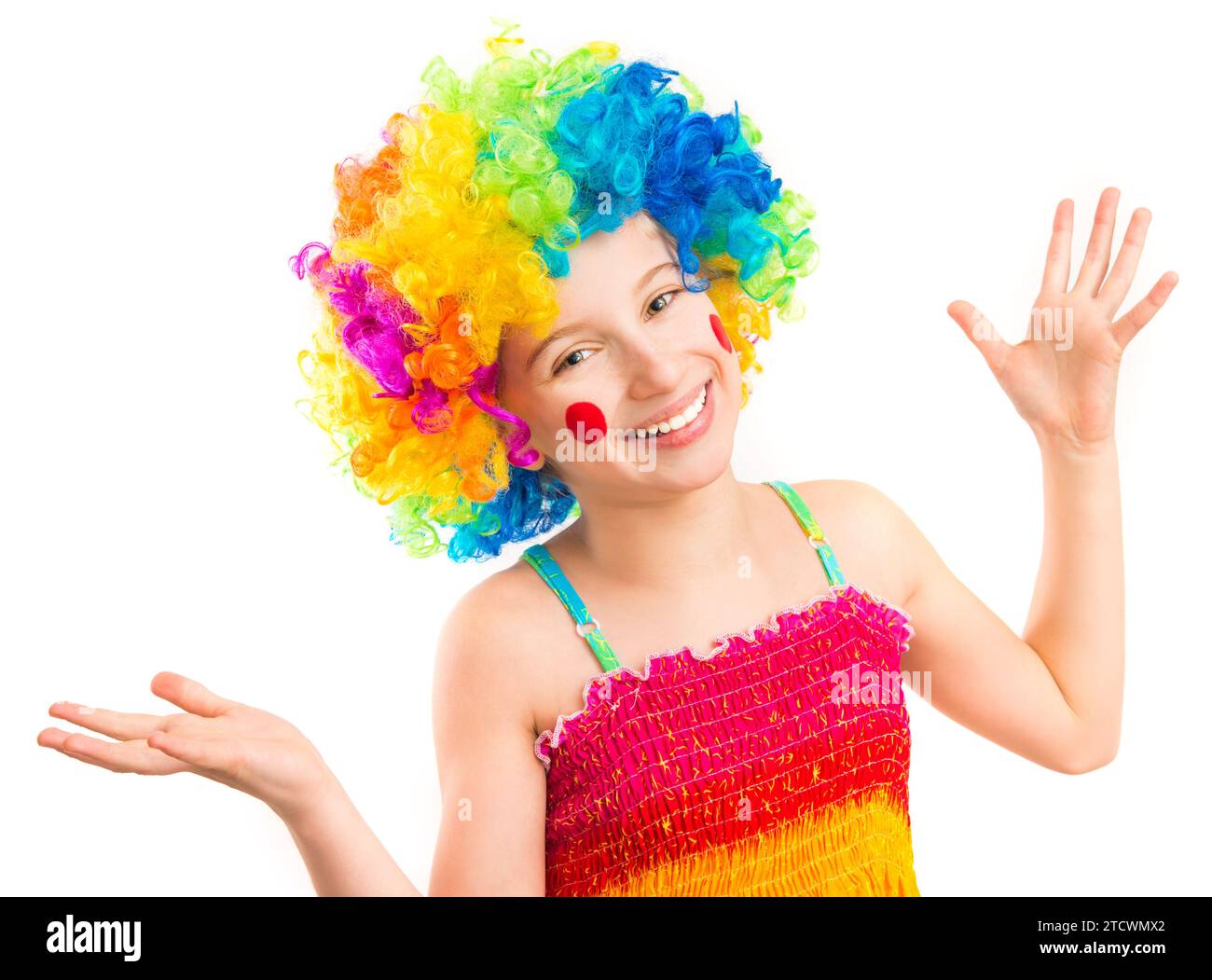 Little girl in funny clown wig with red spots on her cheeks isolated on ...