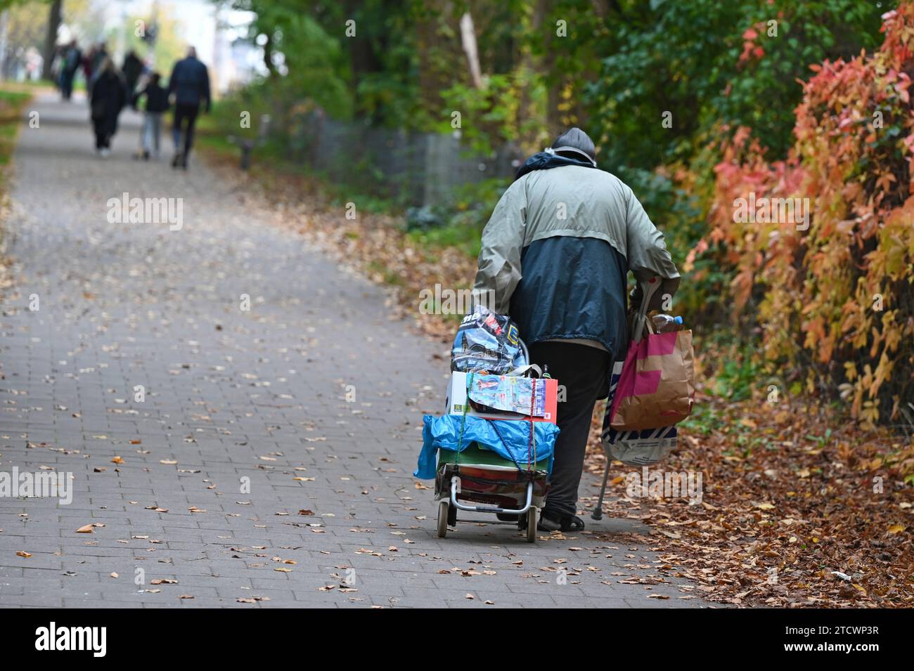 A homeless man from behind in a park in Hamburg, Germany Stock Photo