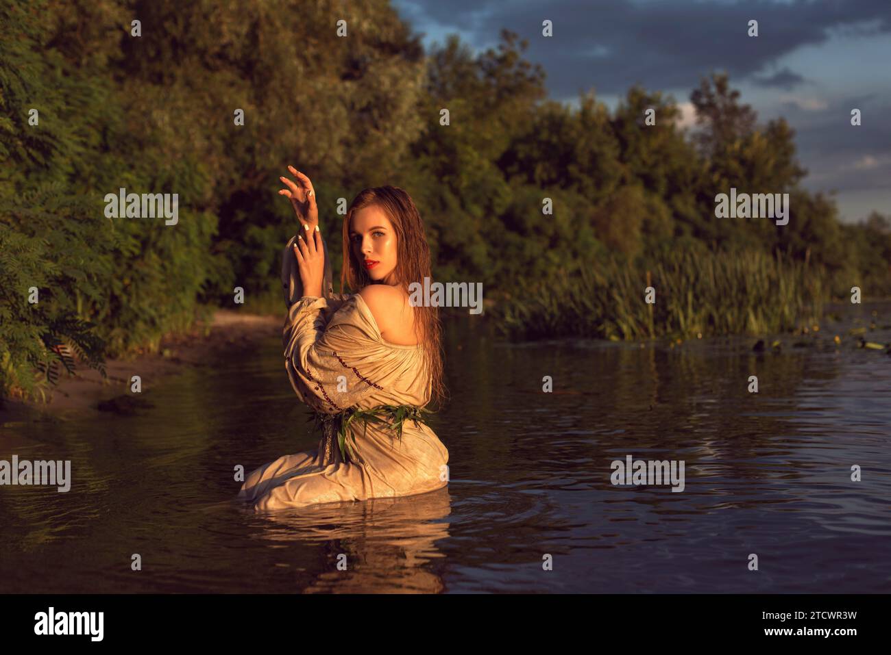Girl in an embroidered dress on the lake Stock Photo - Alamy