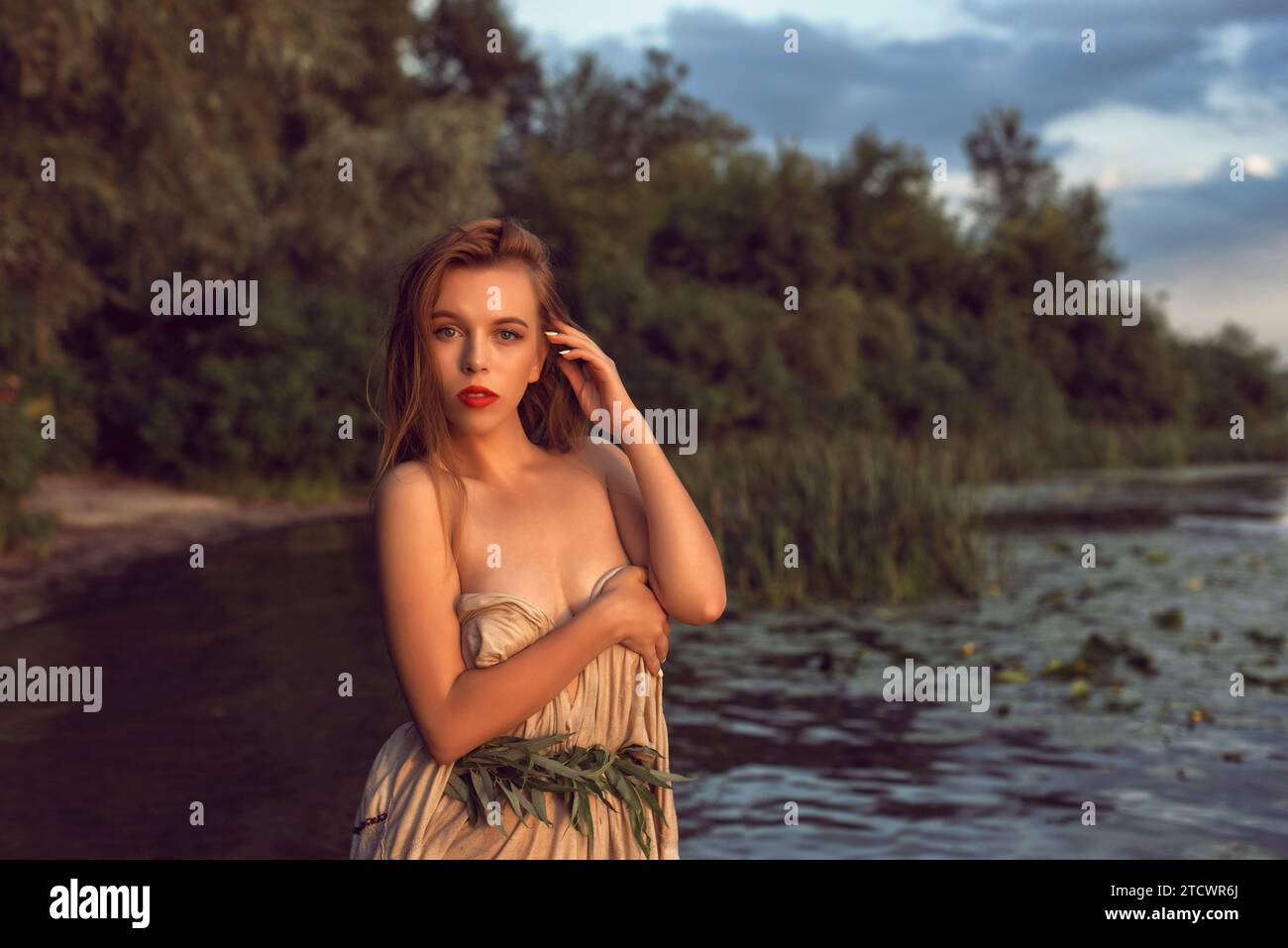 Girl in an embroidered dress on the lake Stock Photo - Alamy
