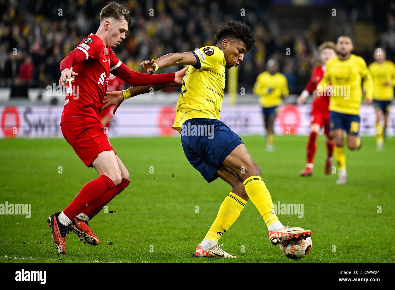 Brussels, Belgium. 14th Dec, 2023. Liverpool's Conor Bradley and Union's Kevin Rodriguez fight for the ball during a game between Belgian soccer team Royale Union Saint Gilloise and English club Liverpool FC, on Thursday 14 December 2023 in Brussels, on the sixth and last day of the group phase of the UEFA Europa League competition, in group E. BELGA PHOTO LAURIE DIEFFEMBACQ Credit: Belga News Agency/Alamy Live News Stock Photo