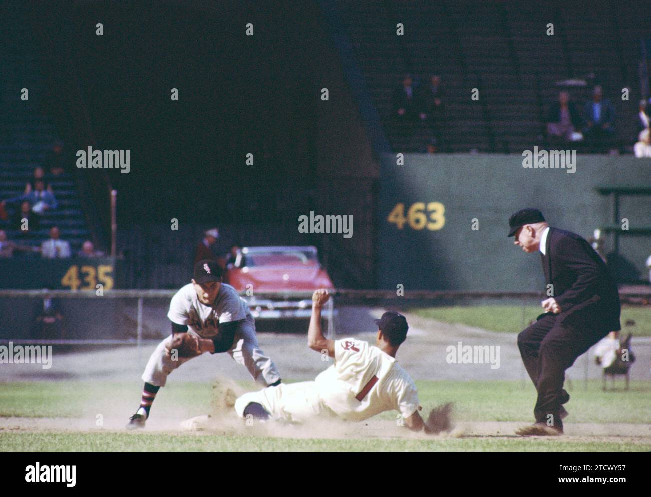 CLEVELAND, OH - MAY 26: Bobby Avila #1 of the Cleveland Indians is caught stealing as Jim Brideweser #3 of the Chicago White Sox puts the tag down as umpire Red Flaherty is there to make the call during an MLB game on May 26, 1955 at Cleveland Municipal Stadium in Cleveland, Ohio.  (Photo by Hy Peskin) *** Local Caption *** Bobby Avila;Jim Brideweser;Red Flaherty Stock Photo