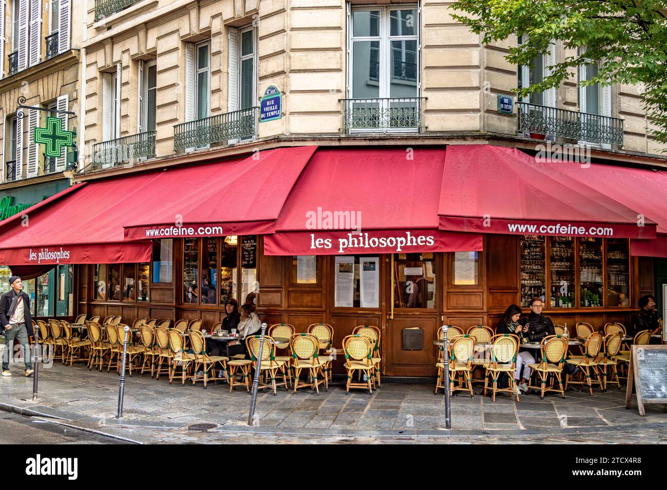 People sitting down on the terrace at  outside Les Philosophes , a French restaurant ,bistro located in the Marais area of Paris, France Stock Photo