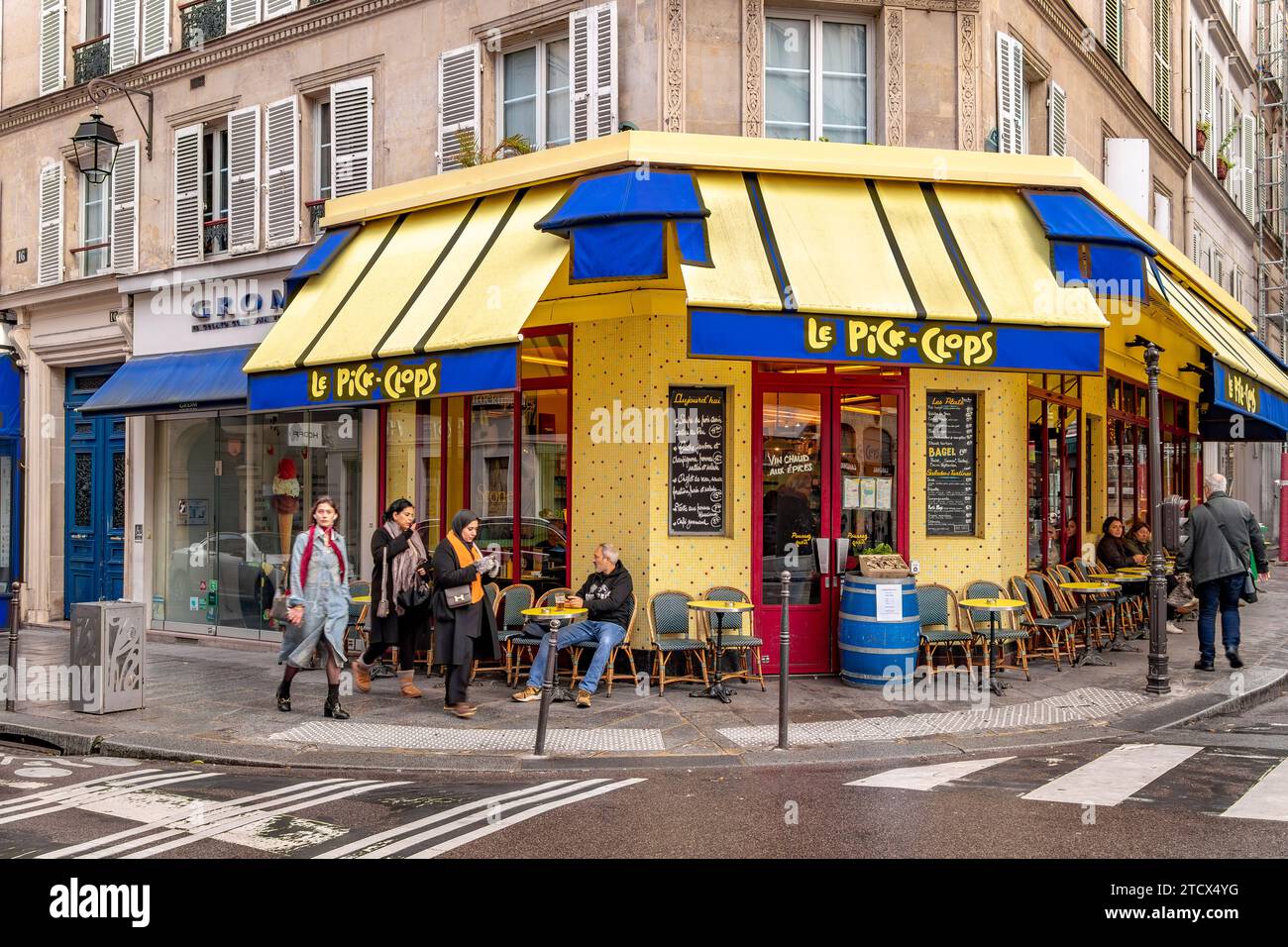 People sitting outside Le Pick Clops a bar ,cafe in the Marais area of Paris, France Stock Photo