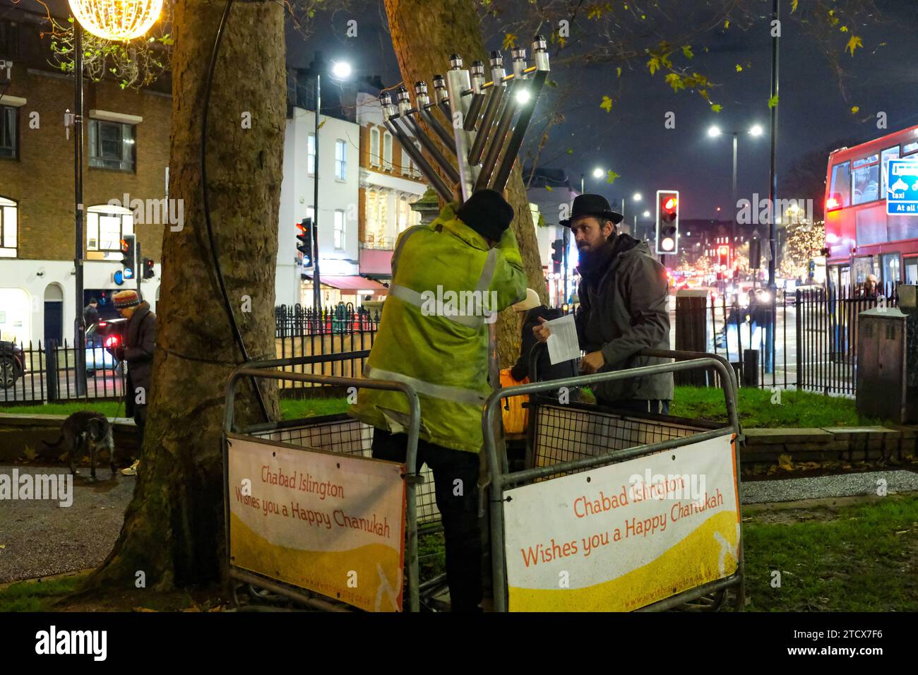 London, UK. 14th December, 2023. A memorah is reinstalled in Islington Green. A solidarity event attended by MPs, community leaders and members of the public was held after the menorah was vandalised earlier today. Rabbi Mendy Korer led the proceedings, relighting the candles  - and the eighth and final one for the Hanukkah festival. The Metropolitan Police investigating, believe that the menorah was intentionally damaged, as antisemitic incidents increase since the Israel-Hamas war was declared. Credit: Eleventh Hour Photography/Alamy Live News Stock Photo
