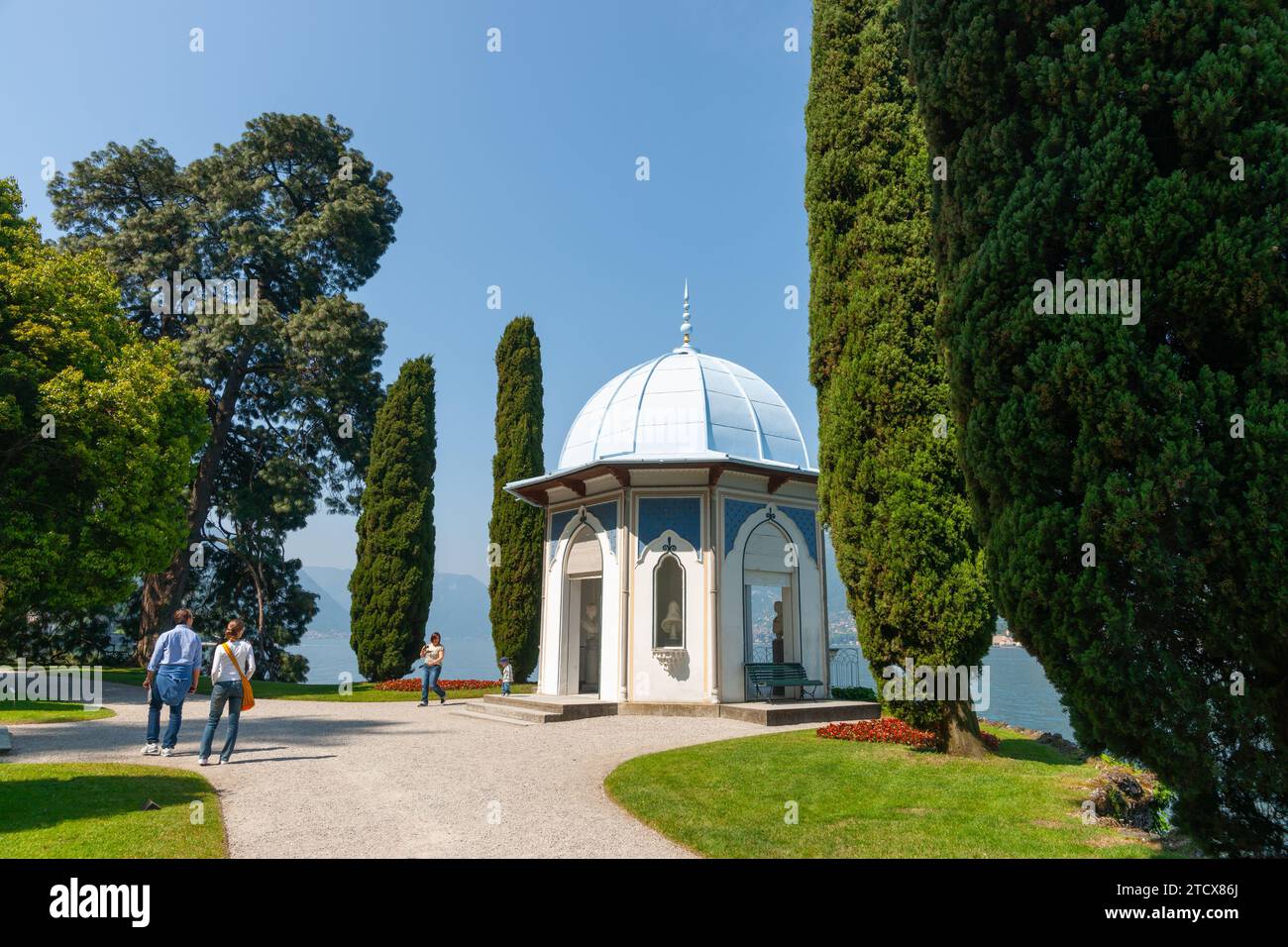 Bellagio Italy - May 8 2011; path leads to Moorish style kiosk surrounded by cypress trees in garden in Bellagio Stock Photo