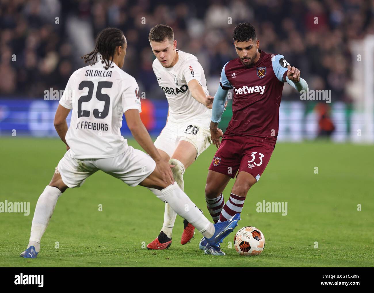 London, UK. 14th Dec, 2023. Emerson Palmieri of West Ham United tackled by Kiliann Sildillia of SC Freiburg during the UEFA Europa League match at the London Stadium, London. Picture credit should read: David Klein/Sportimage Credit: Sportimage Ltd/Alamy Live News Stock Photo