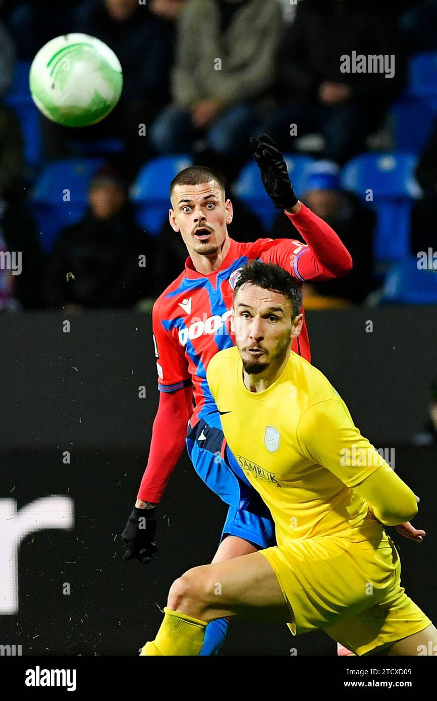 Pilsen, Czech Republic. 14th Dec, 2023. Jan Kliment of Viktoria Plzen, left, and Zarko Tomasevic of Astana in action during the football Conference League 6th round Group C match Viktoria Plzen vs Astana in Pilsen, Czech Republic, December 14, 2023. Credit: Miroslav Chaloupka/CTK Photo/Alamy Live News Stock Photo