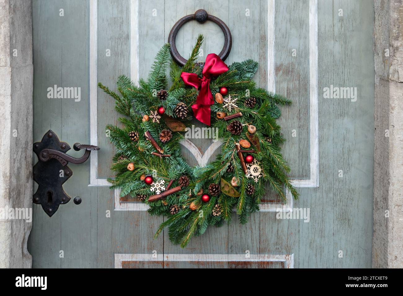 Natural spruce christmas wreath on the door. Stock Photo