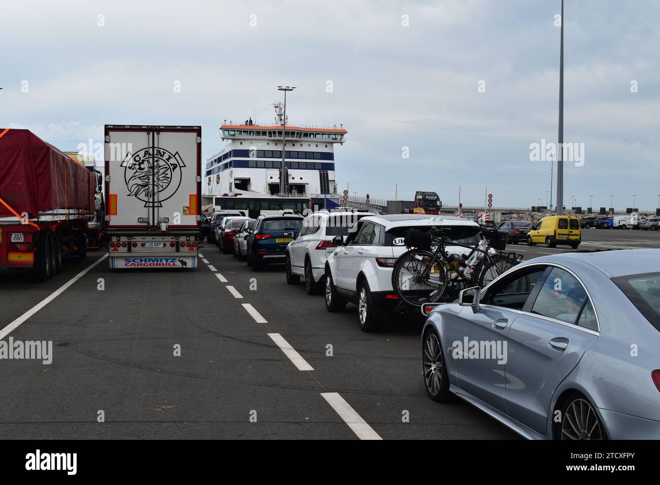 Cars and trucks waiting in line to board the ferry boat at Calais car ferry port Stock Photo