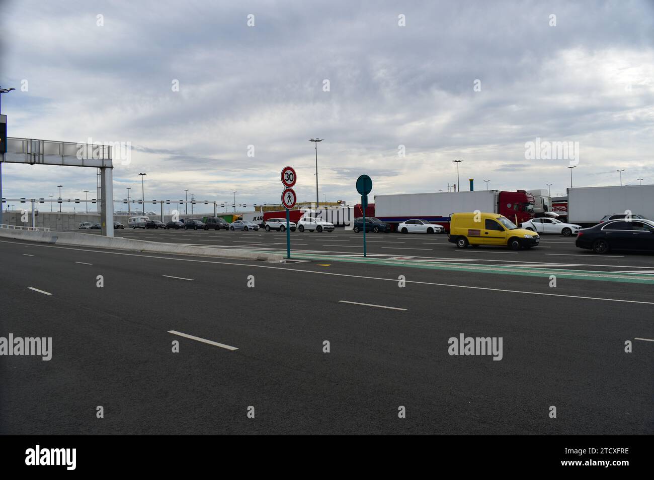 Cars and trucks waiting in line at Calais car ferry port before embarking on the ferry to Dover, UK Stock Photo