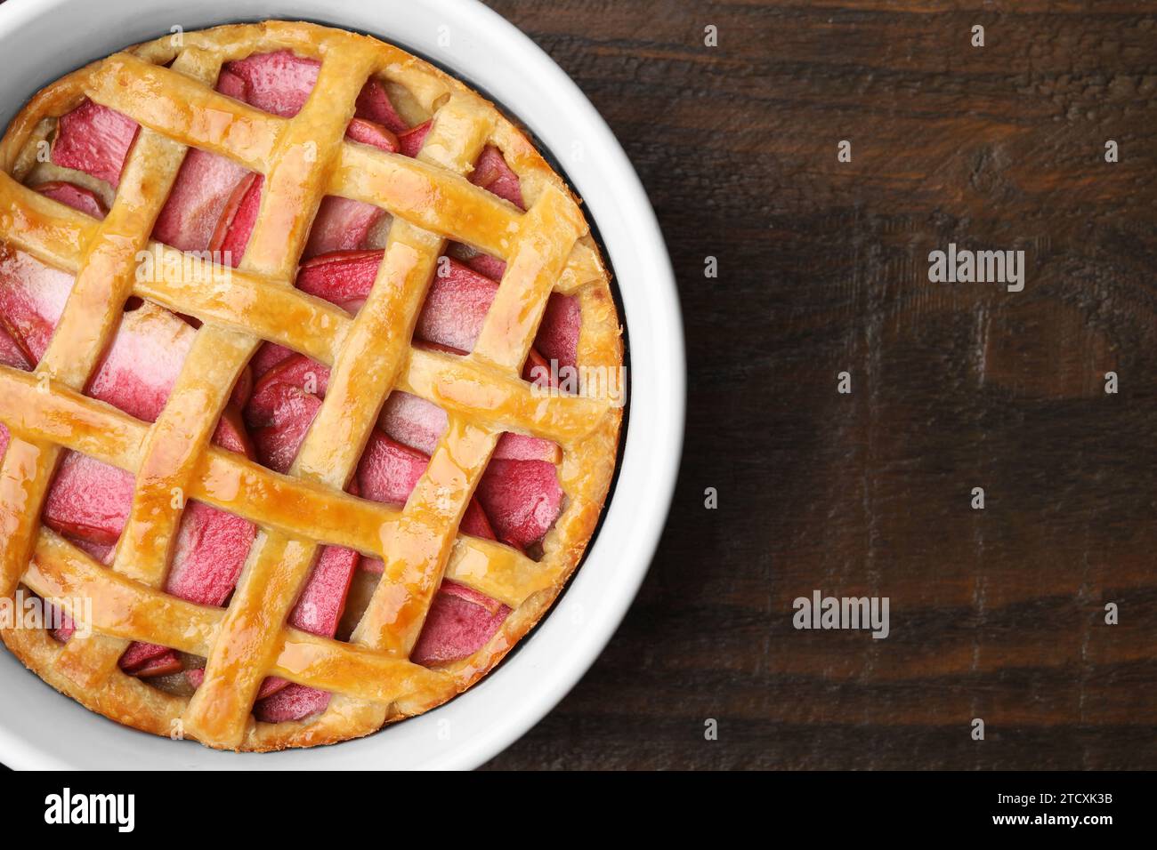 Baking dish with tasty apple pie on wooden table, top view. Space for text Stock Photo
