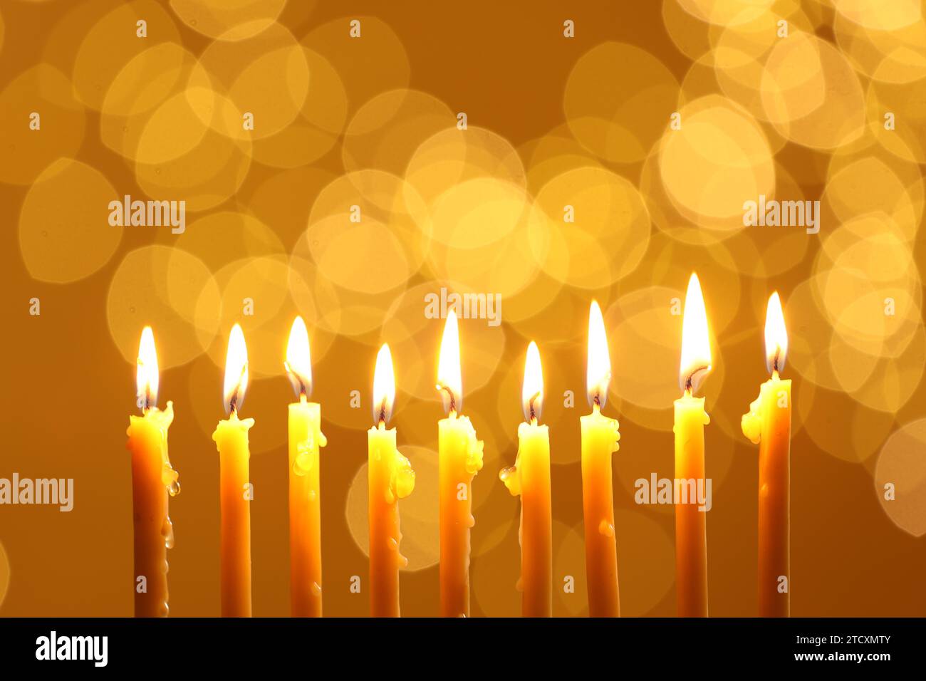 Hanukkah celebration. Burning candles against blurred lights Stock Photo