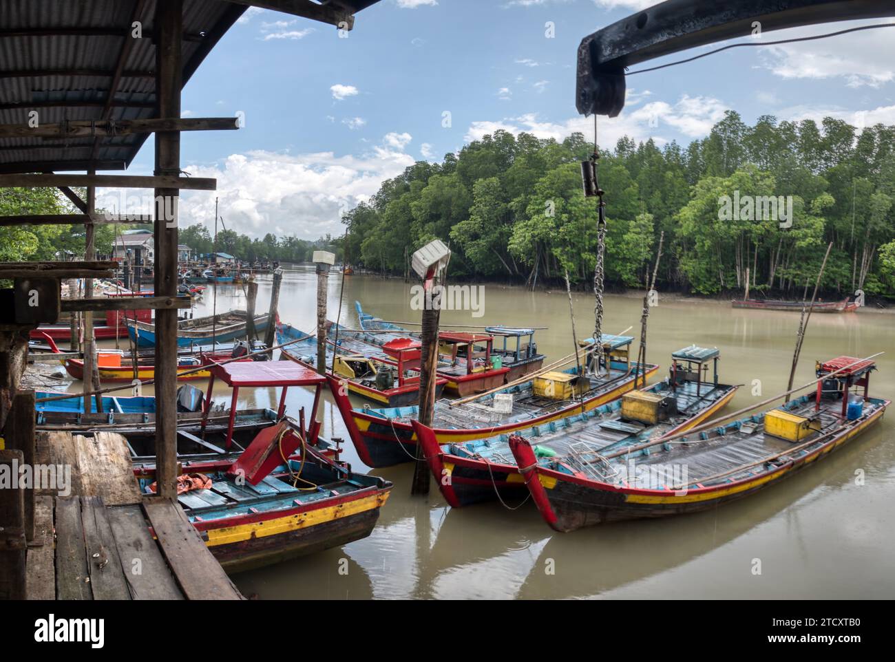 fishing boats docked at the river bank Stock Photo - Alamy