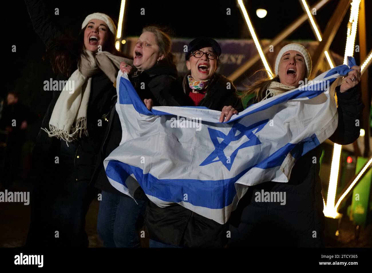 New York, New York, USA. 14th Dec, 2023. Celebrants gather at world's largest Hanukkah menorah at Fifth Ave. at 59th st at Central Park. The giant symbol of Jewish pride in the heart of NYC among the surge in antisemetic incidents .embraces the message of light and hope among the darkness. The 36 foot 4,000 lb. memorah is erected by Chabad-Lubavitch. (Credit Image: © Milo Hess/ZUMA Press Wire) EDITORIAL USAGE ONLY! Not for Commercial USAGE! Stock Photo