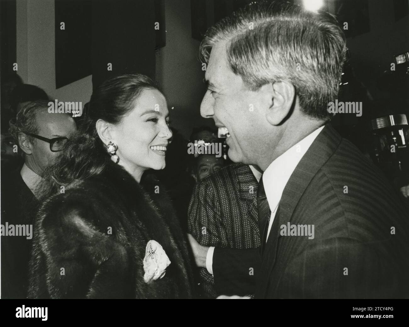 Madrid, 11/03/1987. Mario Vargas Llosa greets Isabel Preysler. In the background, Miguel Boyer. Credit: Album / Archivo ABC / José Sánchez Martínez Stock Photo