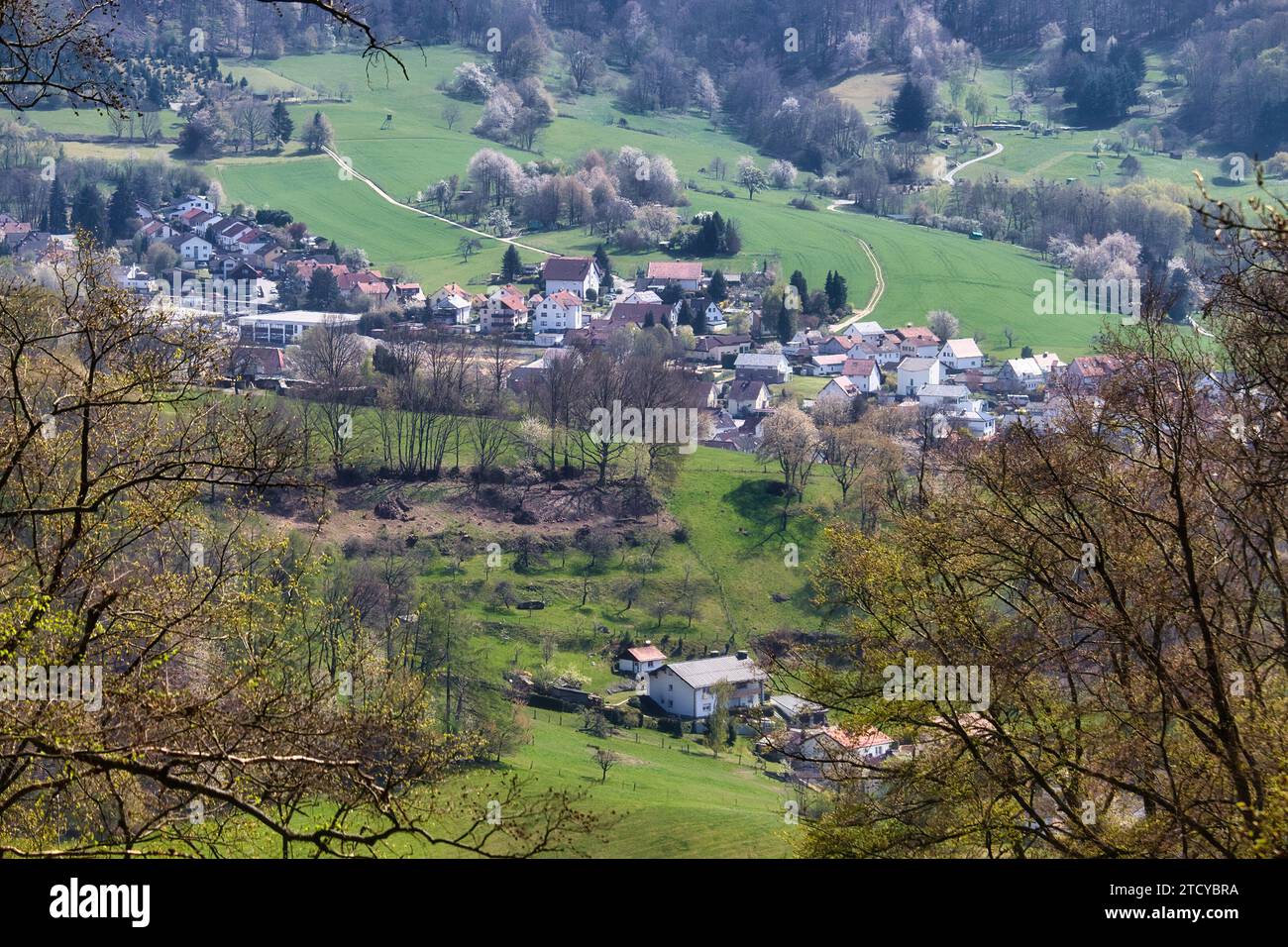 Lautertal, Germany - April 24, 2021: Aerial view of a small German village in a valley with green grass on a spring day at Felsenmeer in Germany. Stock Photo