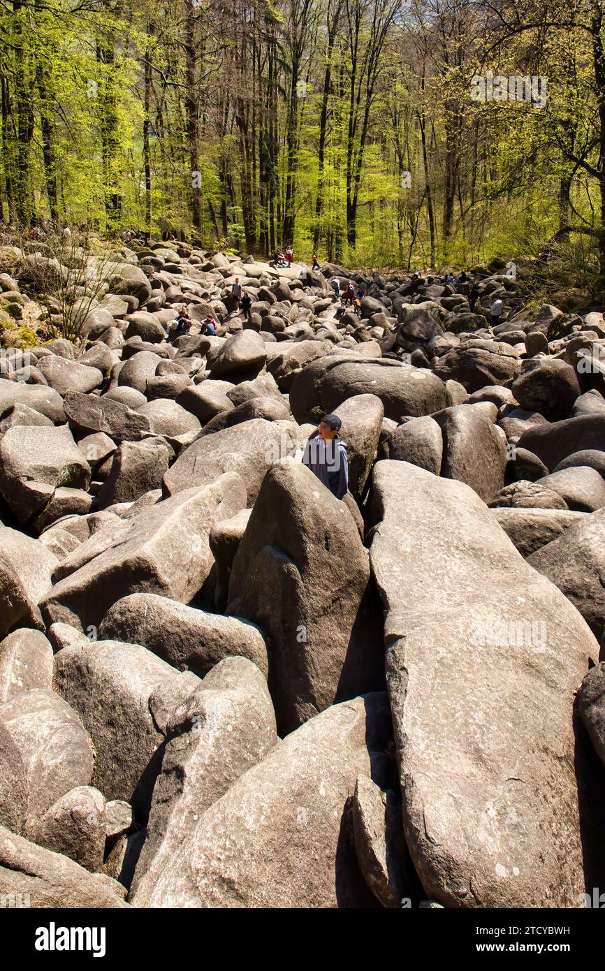 Lautertal, Germany - April 24, 2021: Giant rocks covering a hill at Felsenmeer on a spring day in Germany. Stock Photo