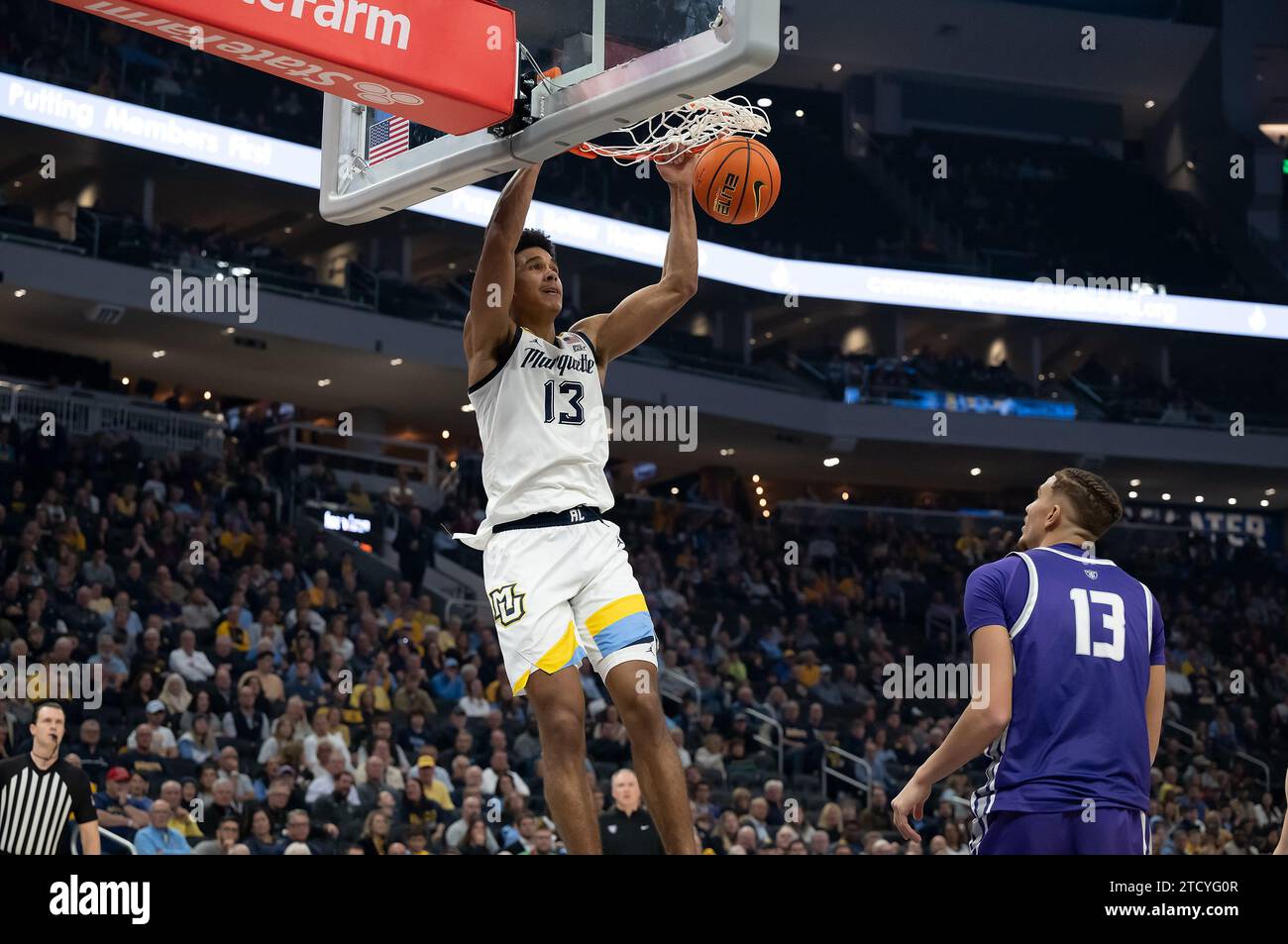 December 14, 2023: Marquette Golden Eagles forward Oso Ighodaro (13) dunks the ball against St. Thomas - Minnesota Tommies forward Ahjany Lee (13) during the NCAA basketball game between St. Thomas - Minnesota Tommies and the Marquette Golden Eagles at the Fiserv Forum in Milwaukee, WI. Kirsten Schmitt/Cal Sport Media. Stock Photo