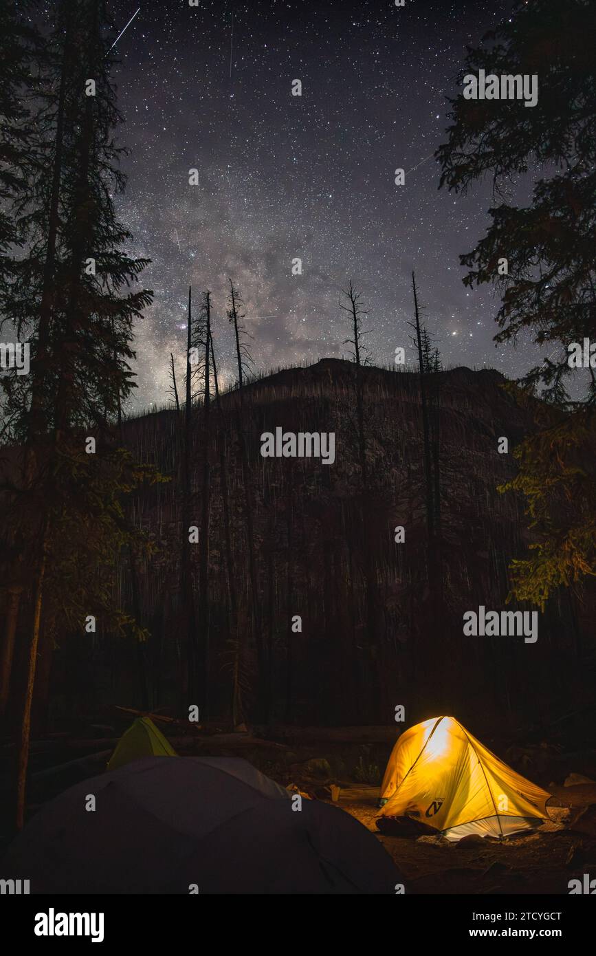 Illuminated tent under the starlit sky of Sunrise Campground in Rocky Mountain National Park. Stock Photo
