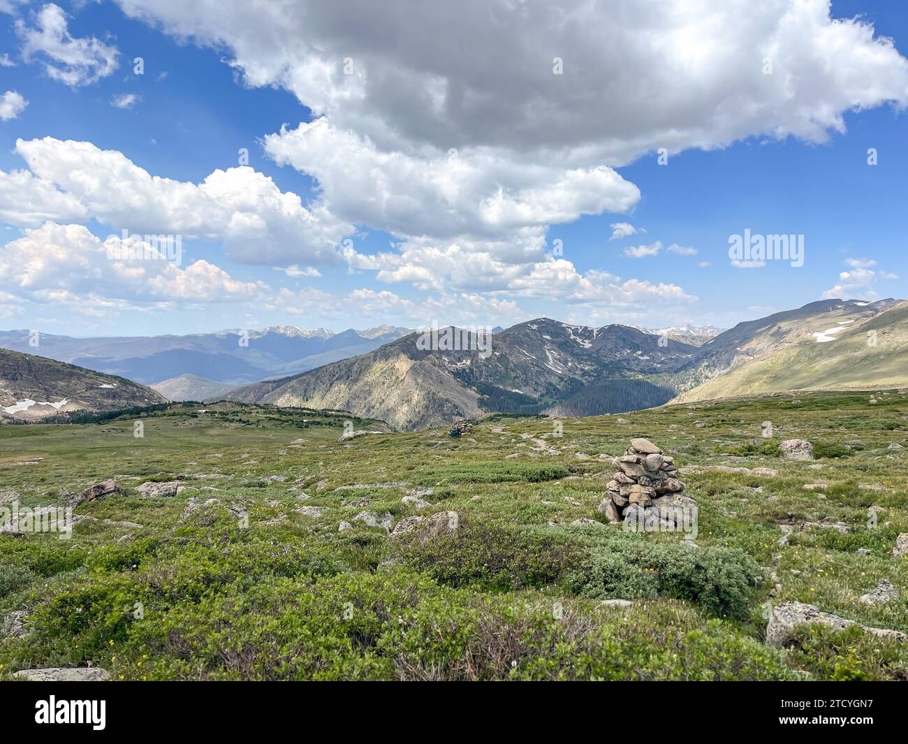 Expansive view of alpine tundra in Rocky Mountain National Park under a cloud-dappled sky. Stock Photo