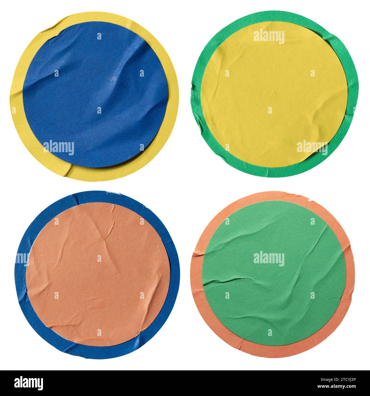 Round blue, yellow, orange and green paper stickers on white background with clipping path Stock Photo