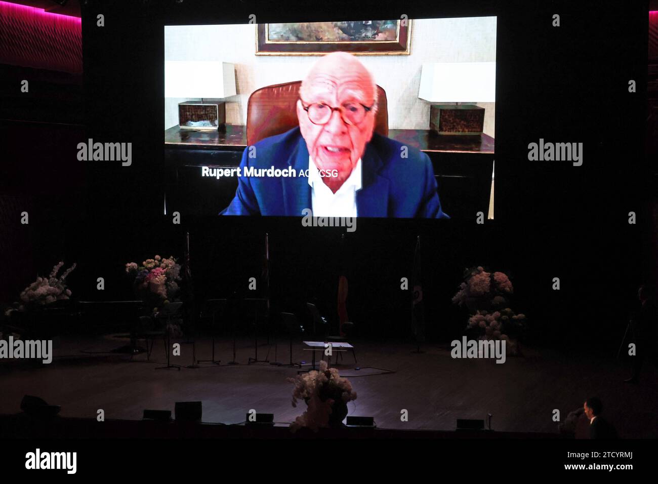 A video tribute from Rupert Murdoch is shown a screen during during the State Memorial Service for Australian comedian and actor Barry Humphries at the Sydney Opera House in Sydney, Friday, December 15, 2023. A State Memorial Service for Barry Humphries will recognise the late entertainers contribution to Australian arts and entertainment. AAP Image/Pool, David Gray NO ARCHIVING SYDNEY NSW AUSTRALIA *** A video tribute from Rupert Murdoch is shown a screen during during the State Memorial Service for Australian comedian and actor Barry Humphries at the Sydney Opera House in Sydney, Friday, Dec Stock Photo