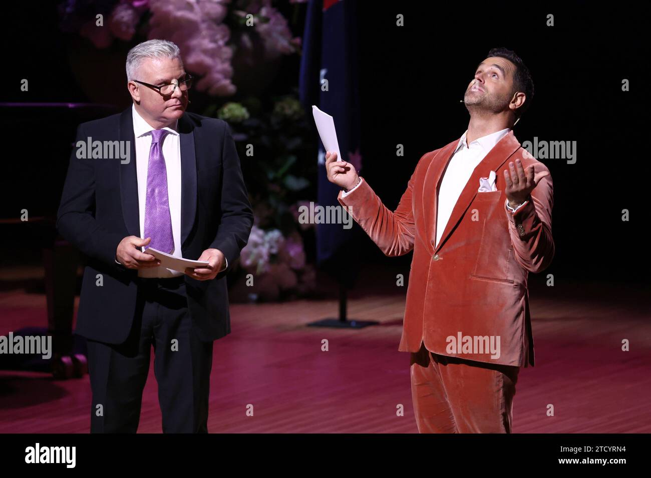 Andrew Ross L and Karl Schmid speak during the State Memorial Service for Australian comedian and actor Barry Humphries at the Sydney Opera House in Sydney, Friday, December 15, 2023. A State Memorial Service for Barry Humphries will recognise the late entertainers contribution to Australian arts and entertainment. AAP Image/Pool, David Gray NO ARCHIVING SYDNEY NSW AUSTRALIA *** Andrew Ross L and Karl Schmid speak during the State Memorial Service for Australian comedian and actor Barry Humphries at the Sydney Opera House in Sydney, Friday, December 15, 2023 A State Memorial Service for Barry Stock Photo